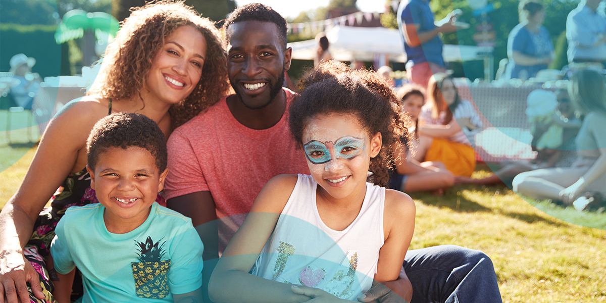 A family smiling in a park