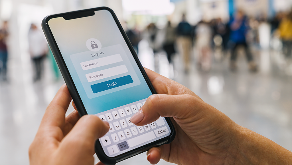 hands holding a mobile phone with a login window open