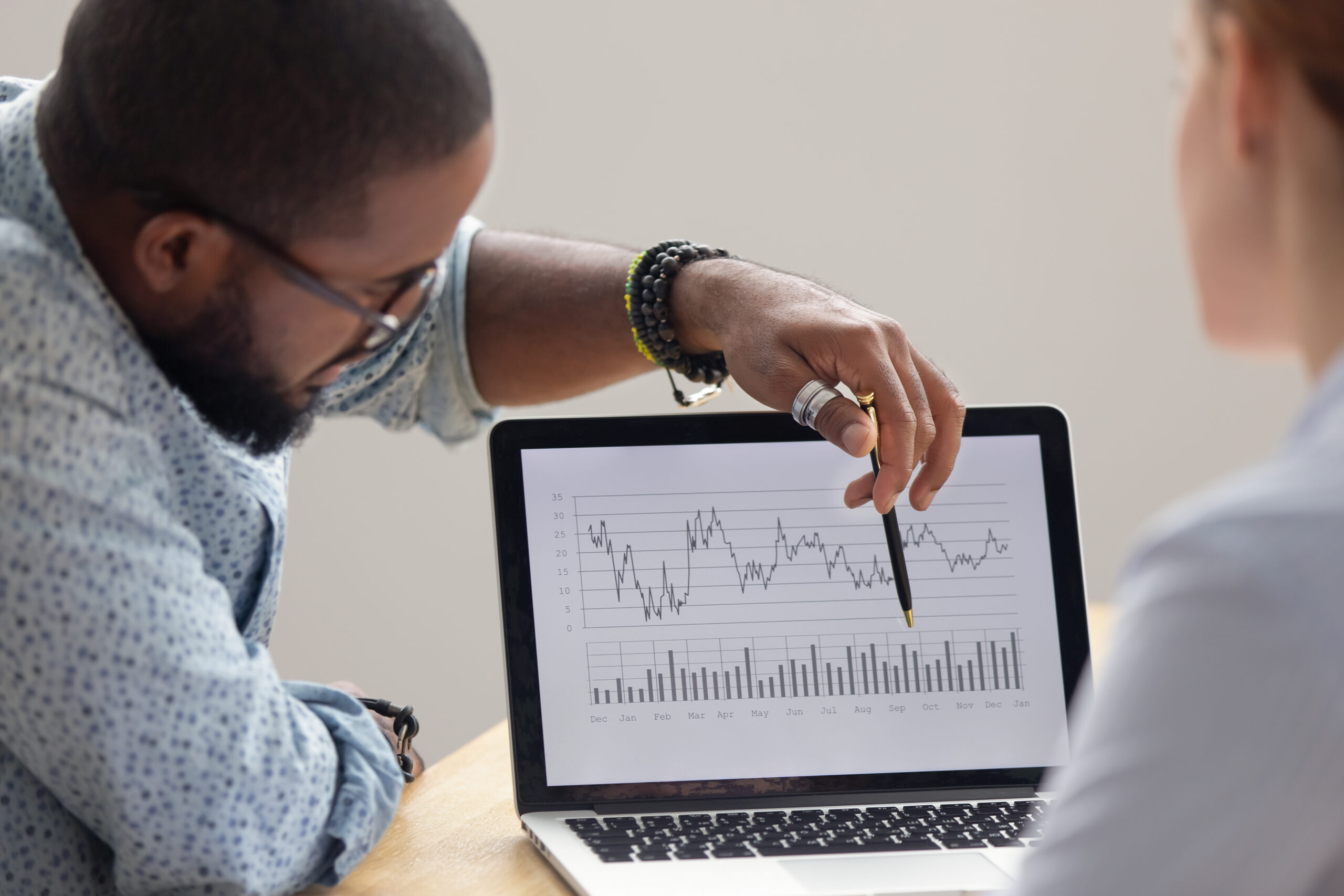 Two non-profit administrators going over an analytical chart