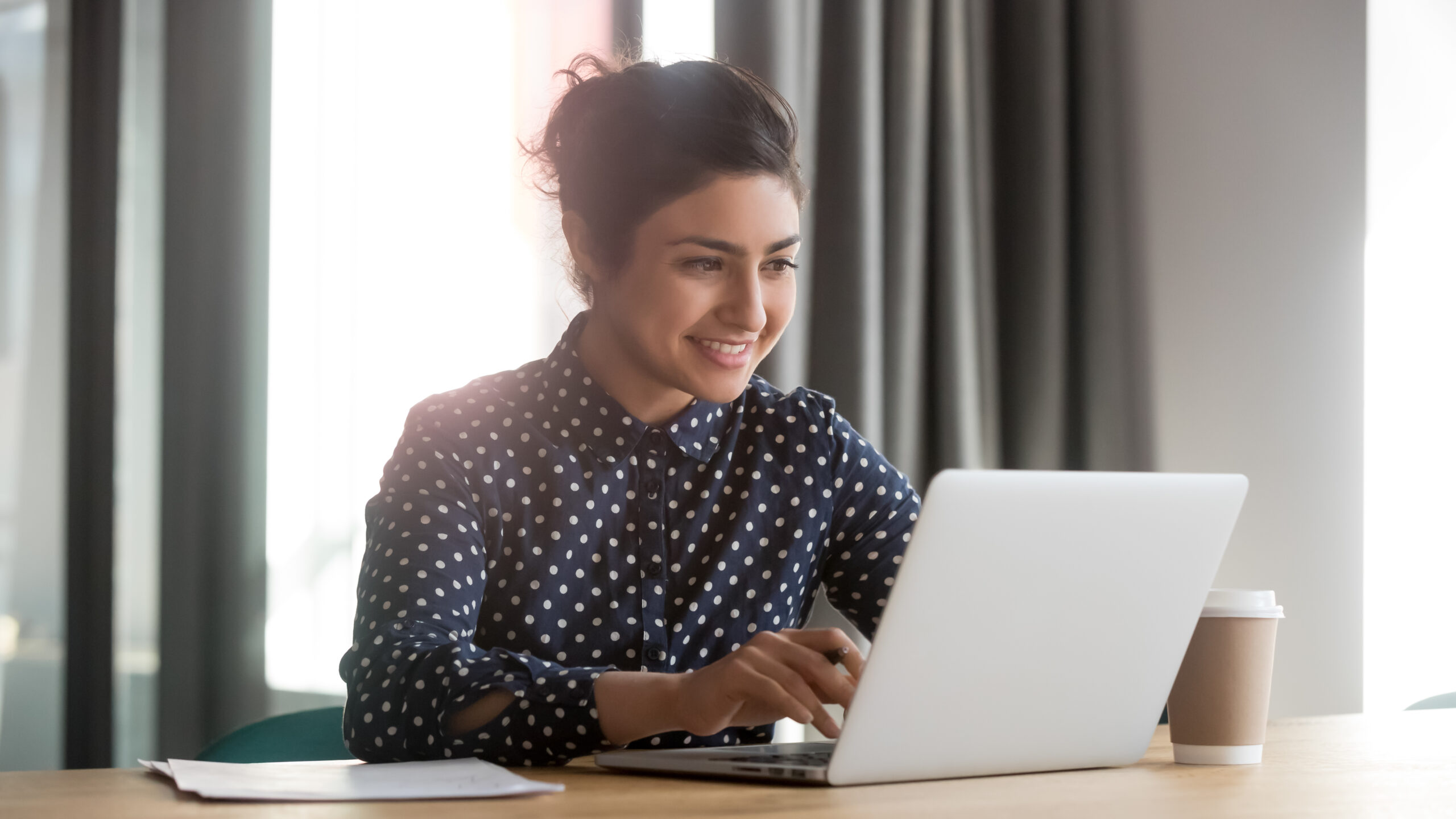 a non-profit volunteer working at her laptop