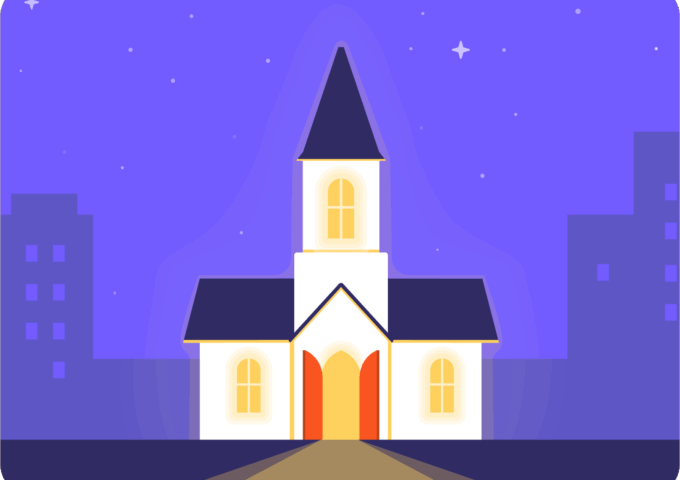 A church shining bright with its lights on on a dark night